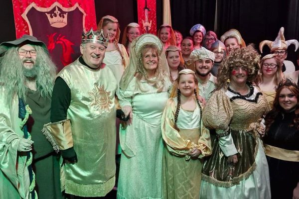 "Members of the Parish Players drama group performing on stage."